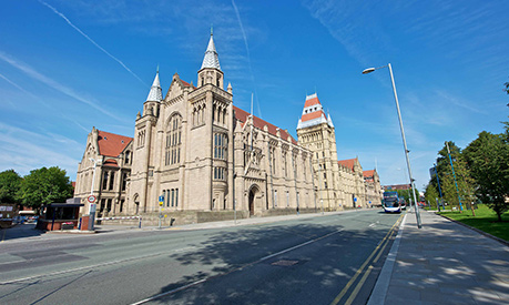 university of manchester arch tower under blue skies 