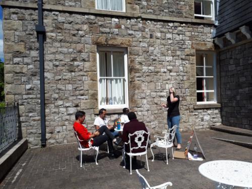 enterprise school relaxing outside grange