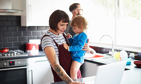 Mother holding child in kitchen young family