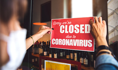 A sign in a shop saying they are closed due to coronavirus