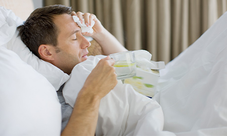 man in bed with illness