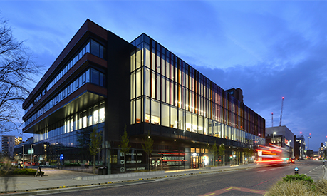 An image of the Alliance Manchester Business School building at night