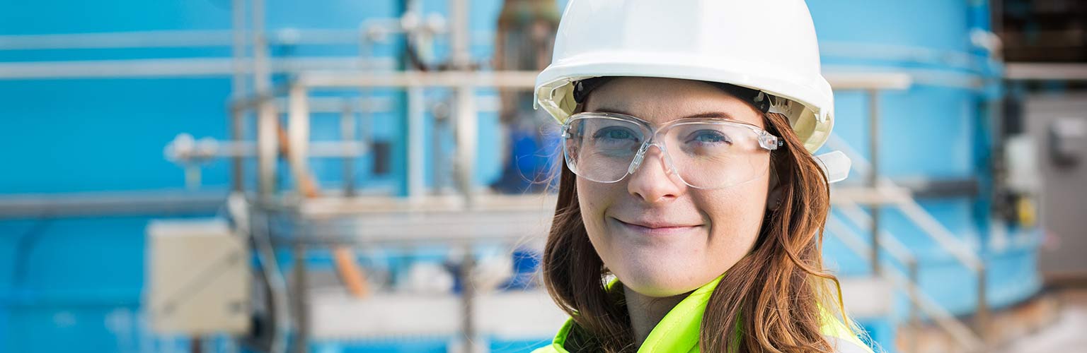 Elle Perschke from British Salt standing in the factory in a hi-vis jacket