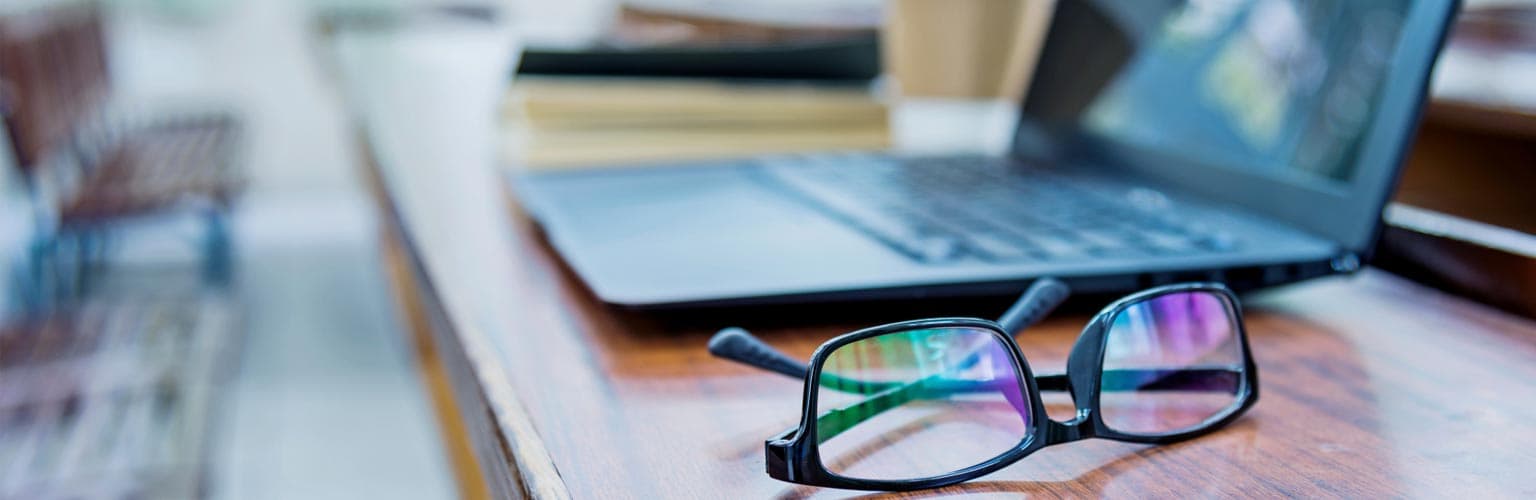 Laptop and glasses on a table