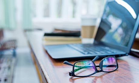 Laptop and glasses on a table