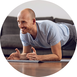 a man exercising at home in a yoga pose