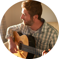 a man playing a guitar indoors