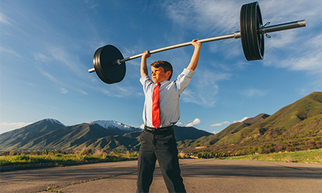 A young businessman lifting weights