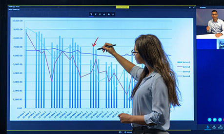 A business woman on a video call editing a graph