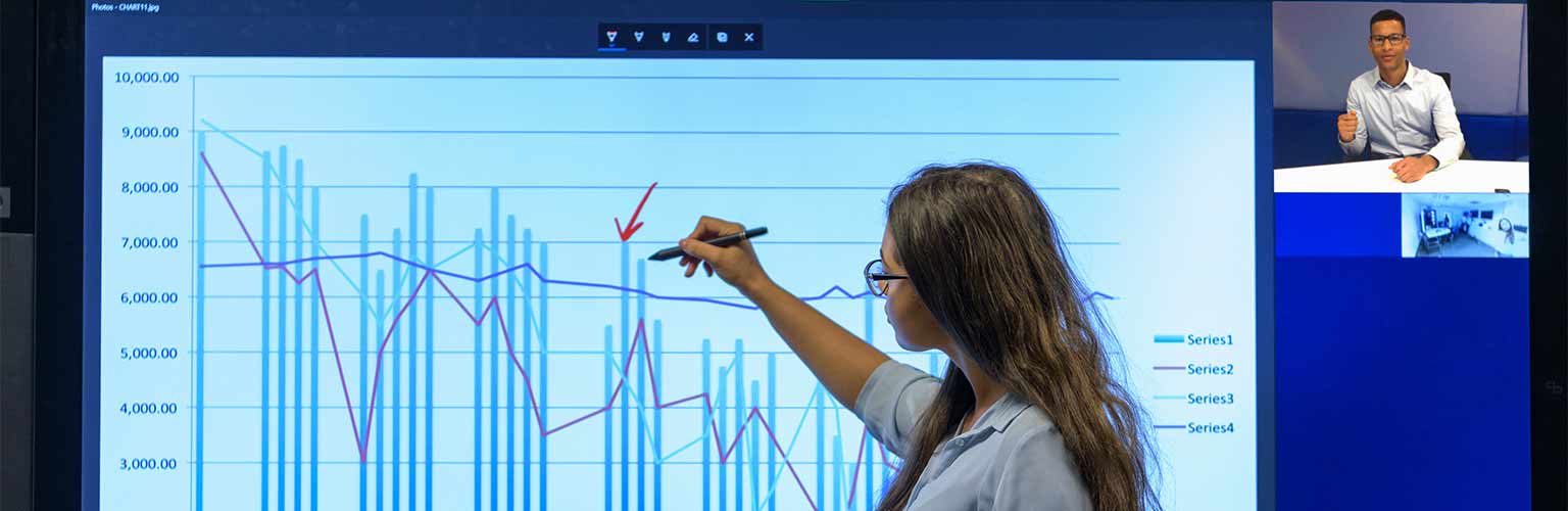 A business woman on a video conferencing call editing a graph