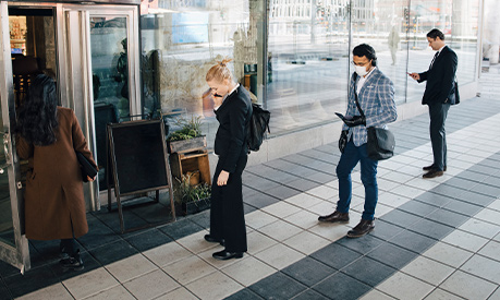 customers waiting outside a cafe social distancing