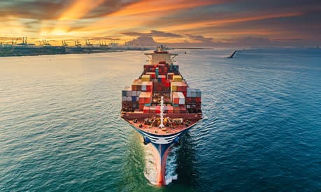 A cargo ship leaves a port