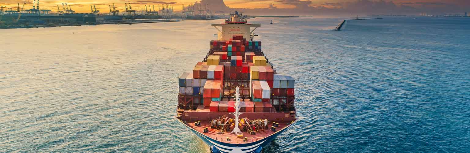 A cargo ship leaving a port 