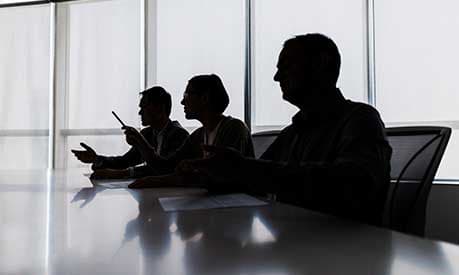 silhouette people board room