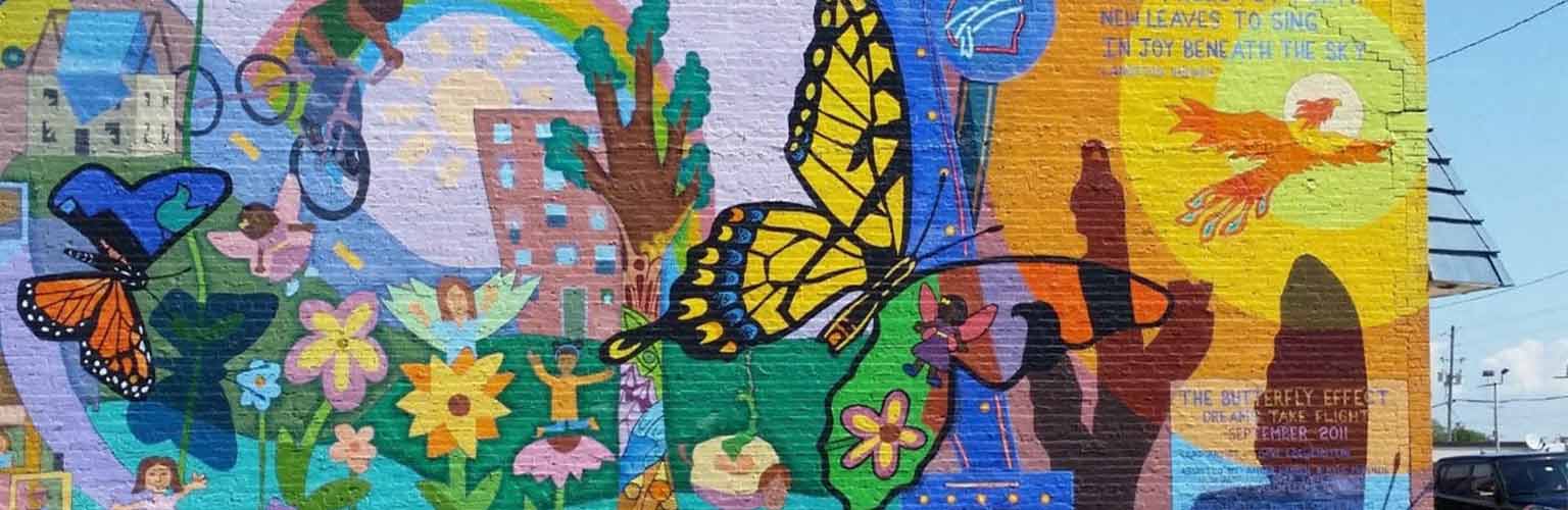 A memorial on a wall with butterflies and rainbows