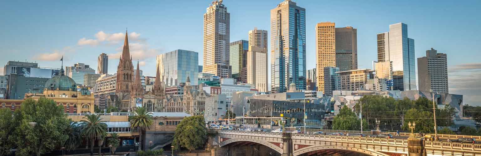 A cityscape of Melbourne in the day time with with a blue sky and in the sunshine