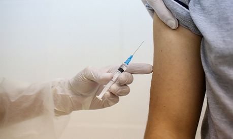 A heath worker prepares to inject the Covid-19 trial vaccine into a patient