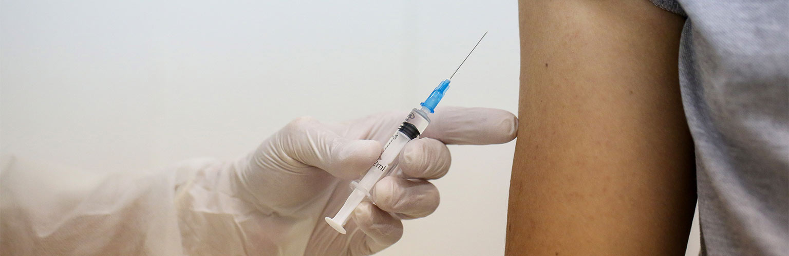 A heath worker prepares to inject the Covid-19 trial vaccine into a patient