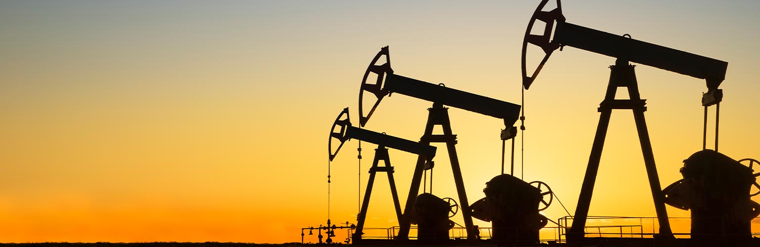 Silhouette of oil wells in desert at sunset, Texas, USA