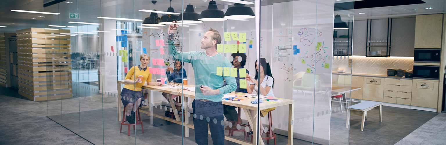 A group of people working in a start-up firm brainstorming in their office