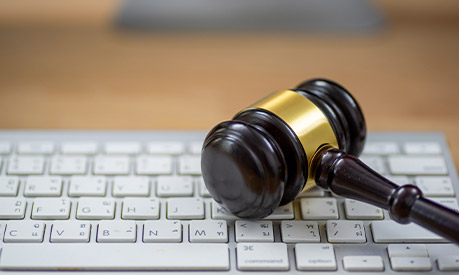 wooden gavel on computer keyboard