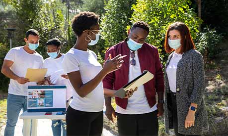 A group of COVID-19 volunteers outside in face masks