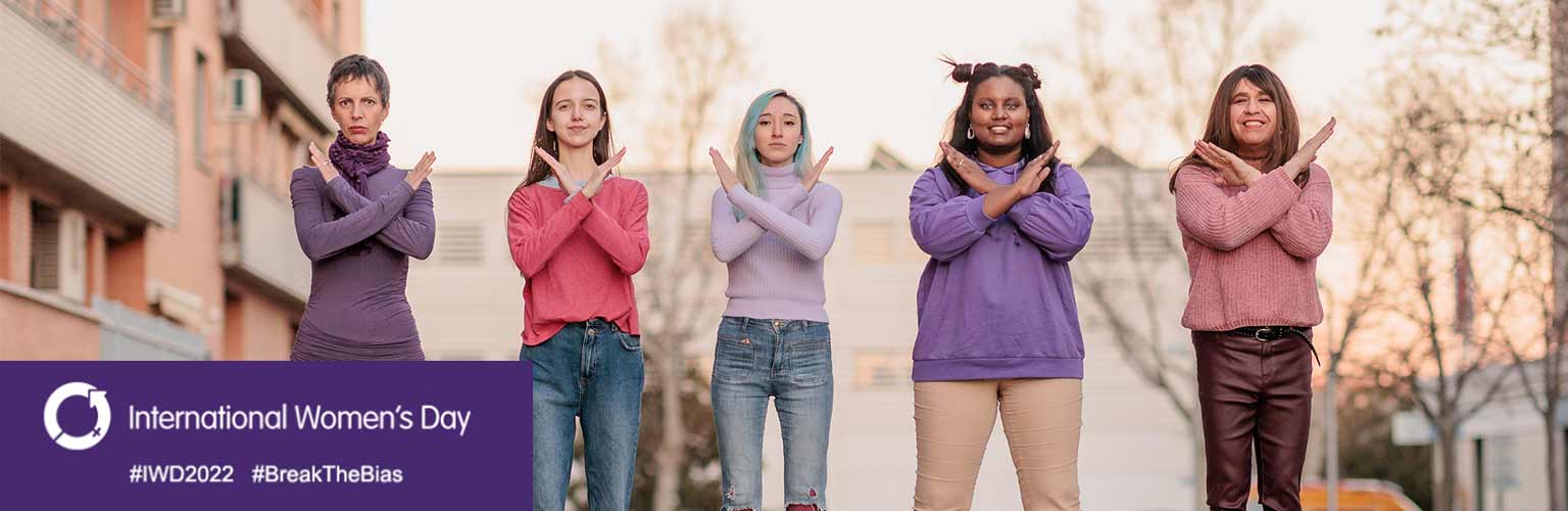 women making cross symbol in a street