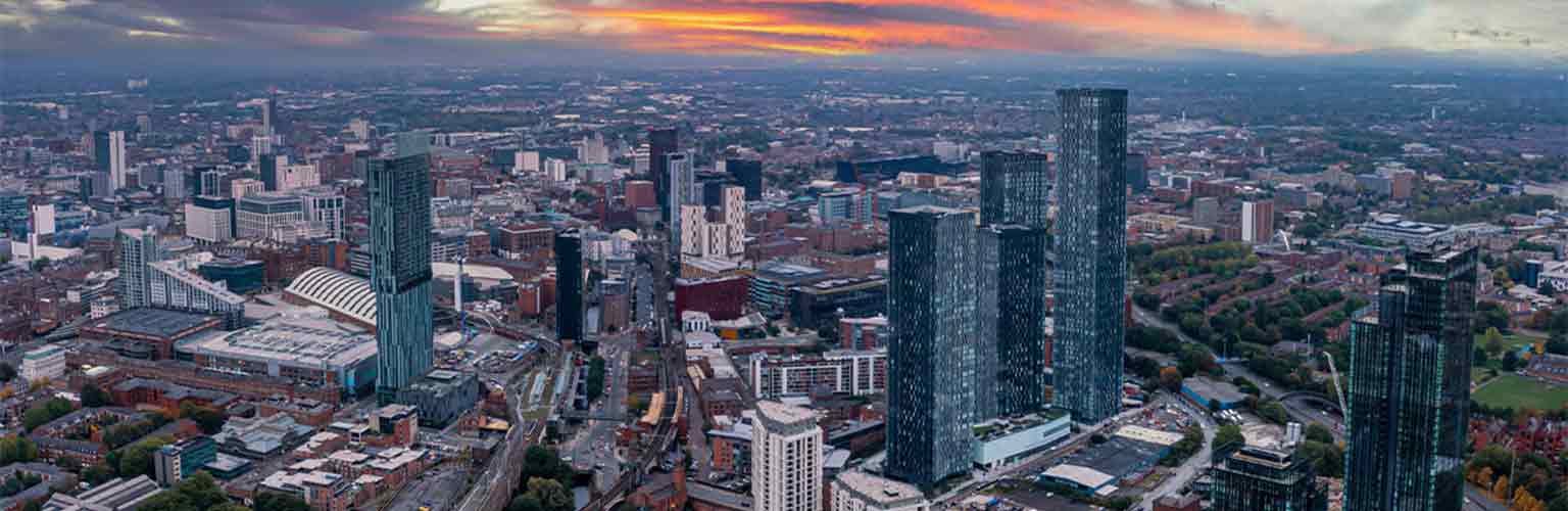 A cityscape of Manchester in the sunset