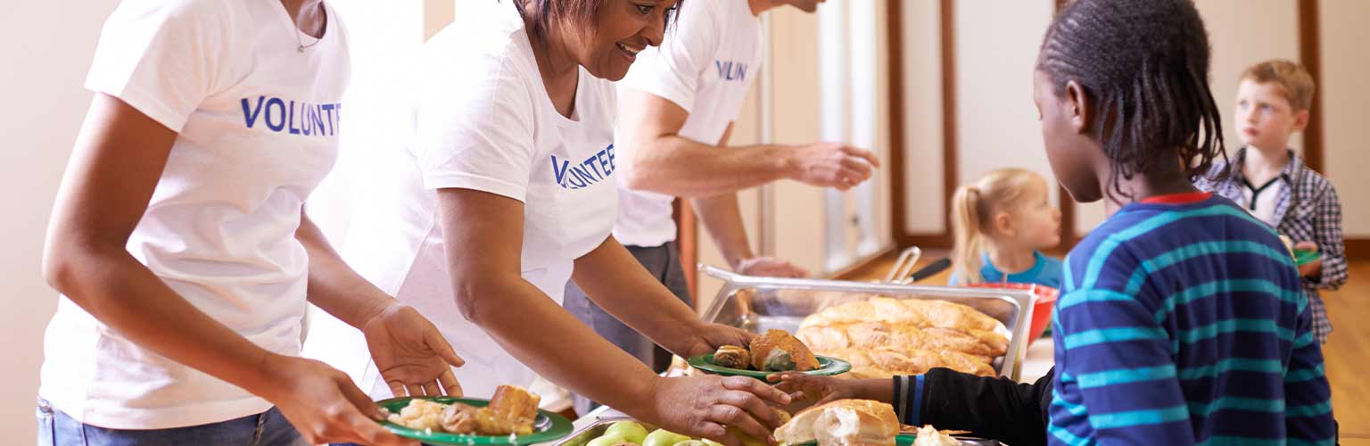 A group of volunteers at a food bank helping deliver food