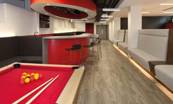 The social area of student accommodation with a pool table in the foreground