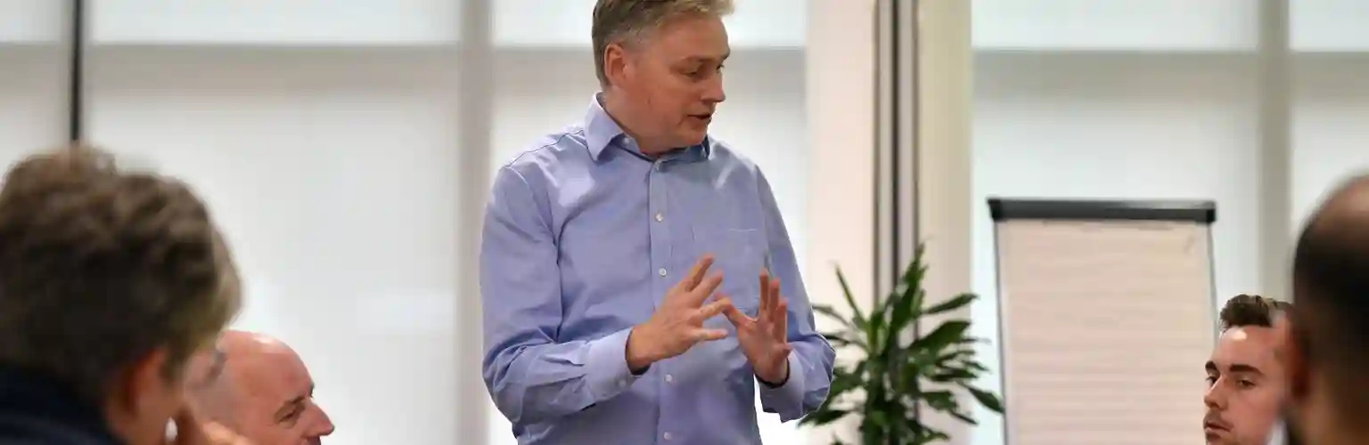 A man addressing a group of executives