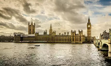 The Houses of Parliament in London overlooking from the other side of the River Thames