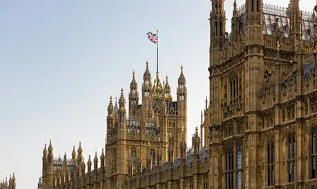 View of the Houses of Parliament with a Union Jack flag