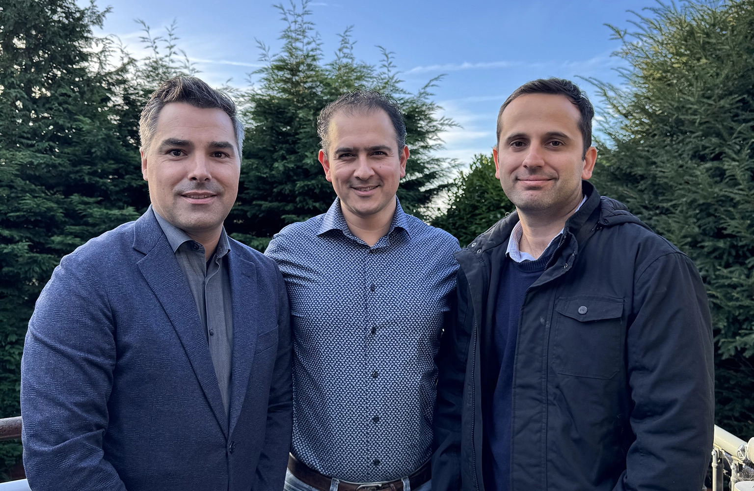 Driverly's core founding team standing together for a photo and smiling.