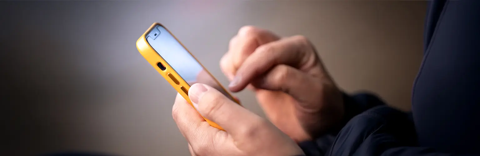 A person typing on a smartphone.