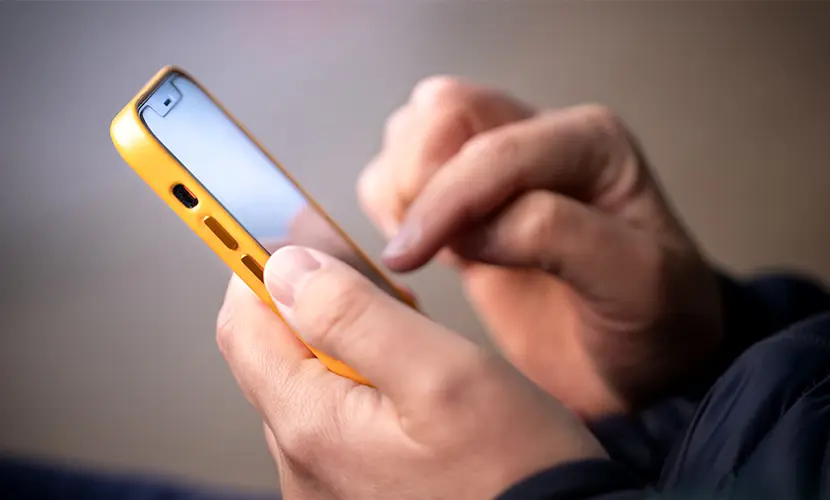A person typing on a smartphone.
