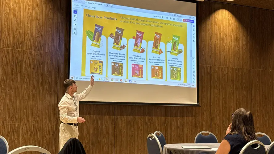 Tom Minnock presenting Chew Chew products in front of an audience.
