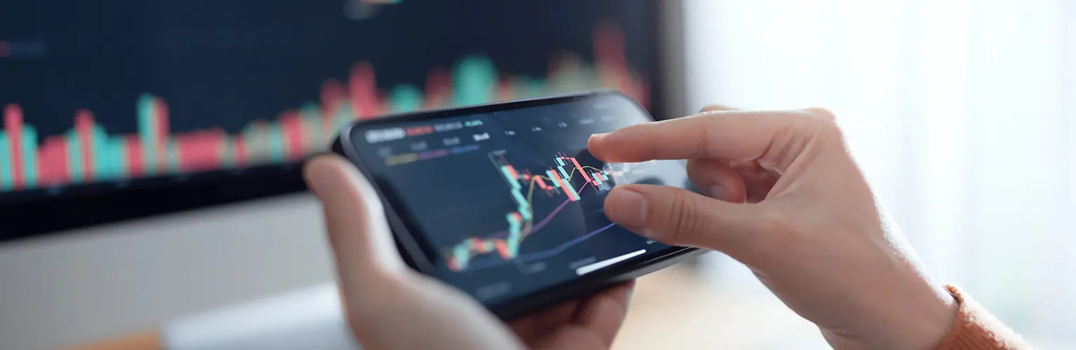 Investors analyse the data stock market index via smartphone screen.