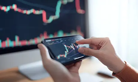 Investors analyse the data stock market index via smartphone screen.
