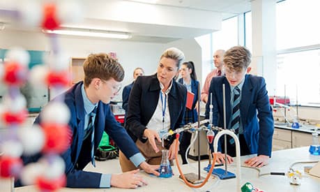 A group of school children learning in a chemistry lesson