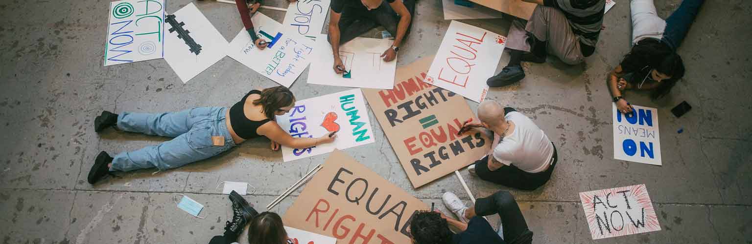 A group of protestors preparing signs for an upcoming march