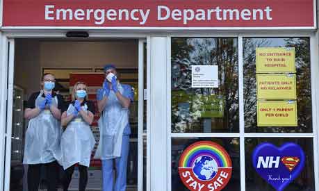 NHS workers clapping in full PPE