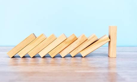 wooden blocks falling over on a table