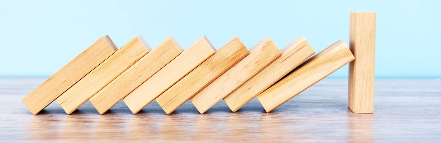 wooden blocks falling over on a table