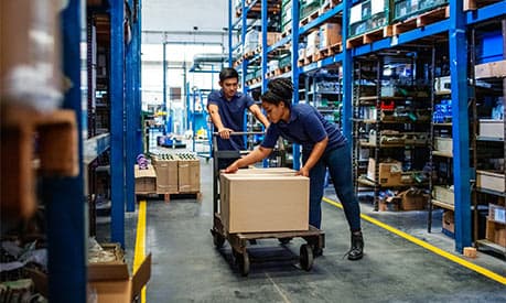 workers in a warehouse unloading a box