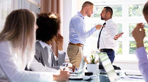 Two men shouting at each other in a business meeting