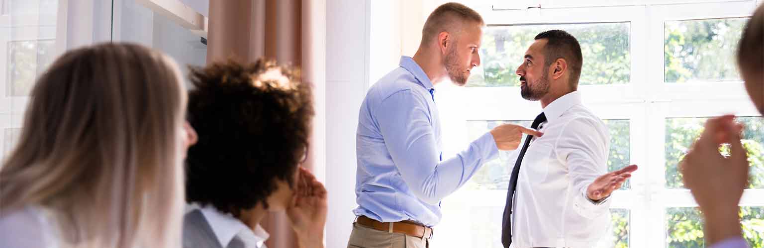 Two men shouting at each other in a business meeting