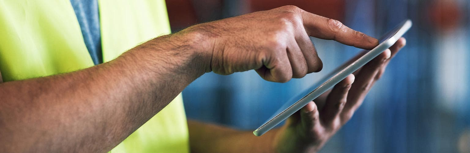 An employee using an ipad in a warehouse