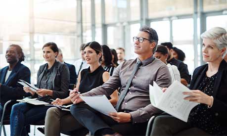 A group of businesspeople sitting down at a conference