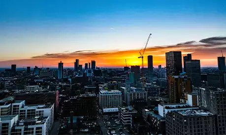 A picture of the Manchester skyline during a sunset